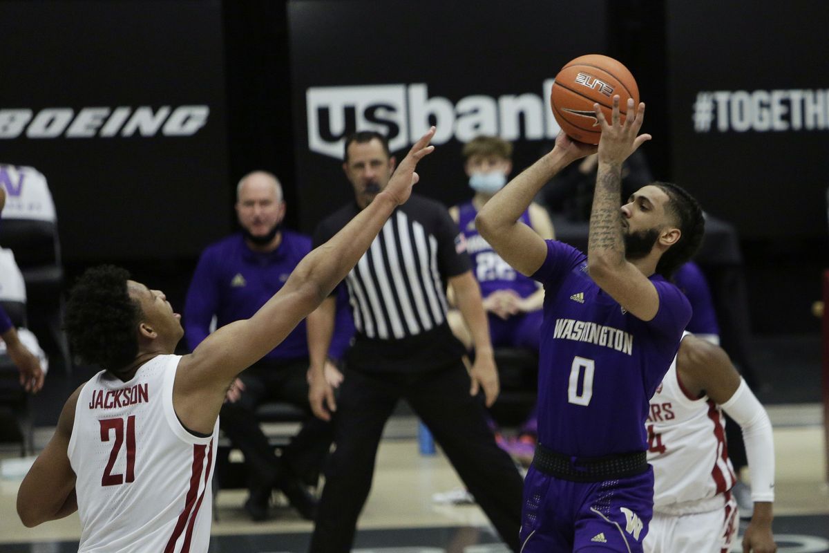 Washington guard Marcus Tsohonis, right, shoots over Washington State center Dishon Jackson during the second half in Pullman on Monday. (Associated Press)