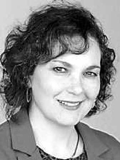 
 Mary DeLateur, left, and her friend Cindy Guenther, tie up a yellow ribbon at the intersection of Argonne and Upriver Drive in the Spokane Valley Tuesday. DeLauter's son Andrew returns from Iraq on Thursday.  
 (Liz Kishimoto / The Spokesman-Review)