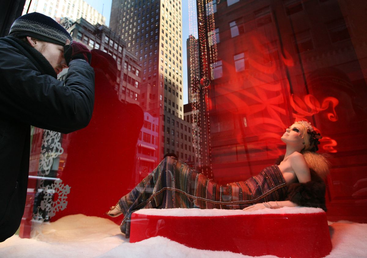 A man stops to look at a Saks Fifth Avenue window display in New York. Wealthy Americans are slashing their spending at a rate unseen in decades. Luxury sales overall dropped 34.5 percent in the first week of December.Associated Press photos (Associated Press photos / The Spokesman-Review)