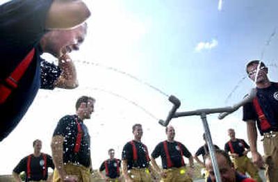 
Valley Fire recruit Darren Cromeenes, left, takes water after a strenuous confidence-builder exercise at Fire Academy 2004 at the Valley Fire training tower Friday afternoon. The recruits had to do drills with all of their personal protective gear. 
 (Holly Pickett / The Spokesman-Review)