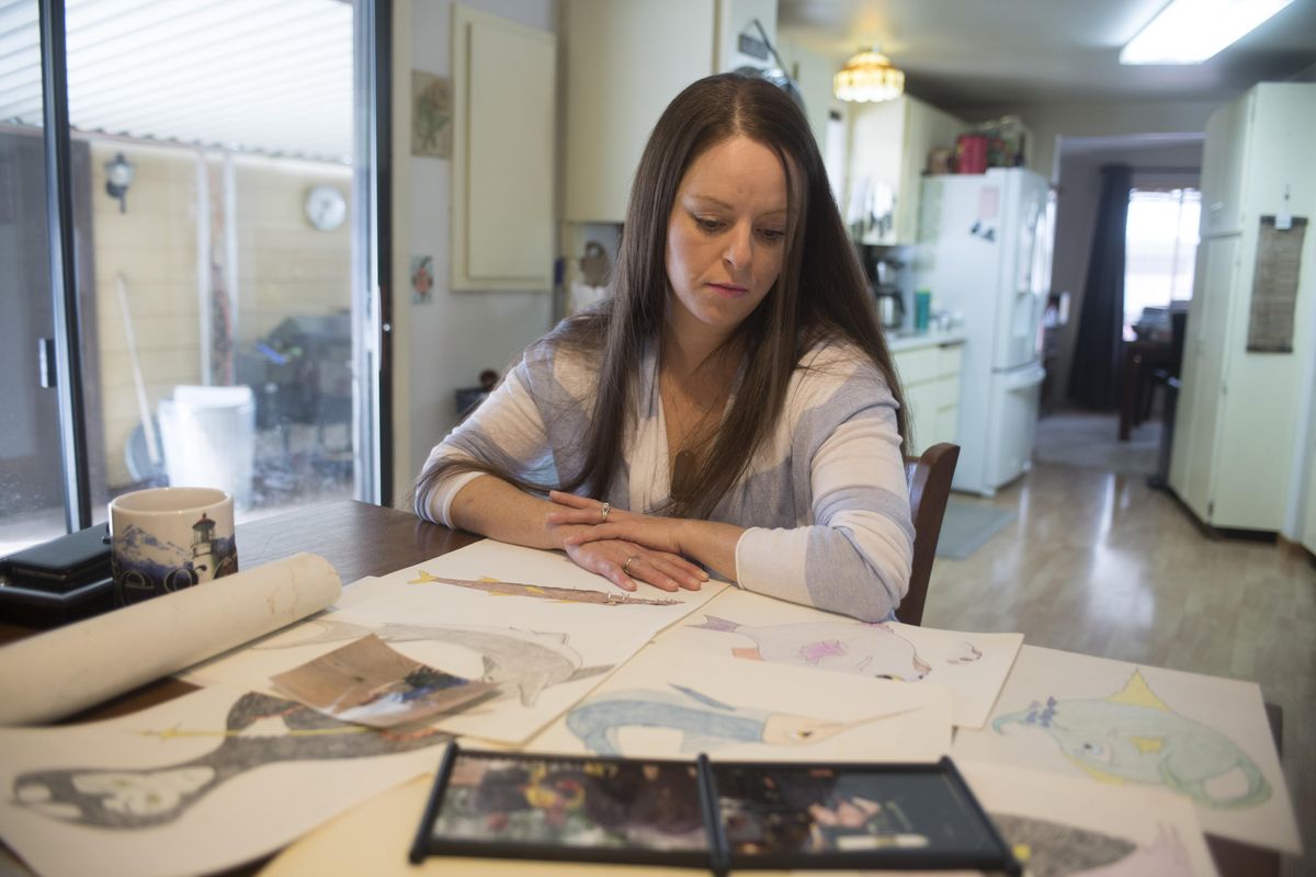 Tami Cleveland looks at sketches made by her stepmother, Beth Cleveland, at her home in Rosalia Sunday, Mar. 12, 2017.  Beth Cleveland, a hospice nurse, died of a painkiller overdose in 2012. The veteran nurse had sought the painkillers for debilitating headaches, but inadvertently overdosed.   Jesse Tinsley/THE SPOKESMAN-REVIEW (Jesse Tinsley / The Spokesman-Review)