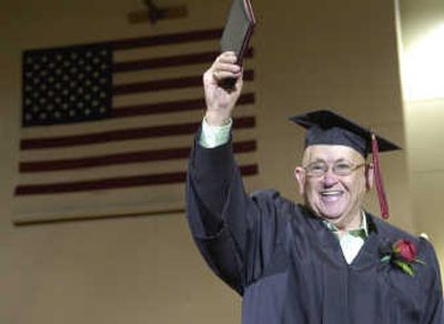 
Bob Tiffany, age 81, shows off his high school diploma during an Veterans Day assembly Nov. 9 at North Central High School in Spokane. Tiffany was drafted into the Navy and never got him diploma. 
 (Dan Pelle / The Spokesman-Review)