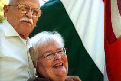 
Ferenc and Jolene Feher pose for a portrait  between the Hungarian and U.S. flags. 
 (INGRID BARRENTINE / The Spokesman-Review)