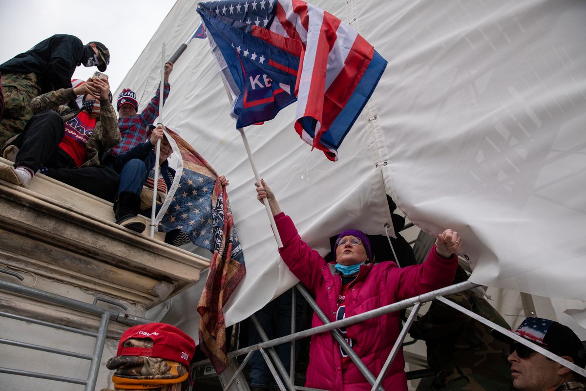 Rioters climb scaffolding around the U.S. Capitol building on Jan. 6, 2021. (Amanda Andrade-Rhoades/For The Washington Post)