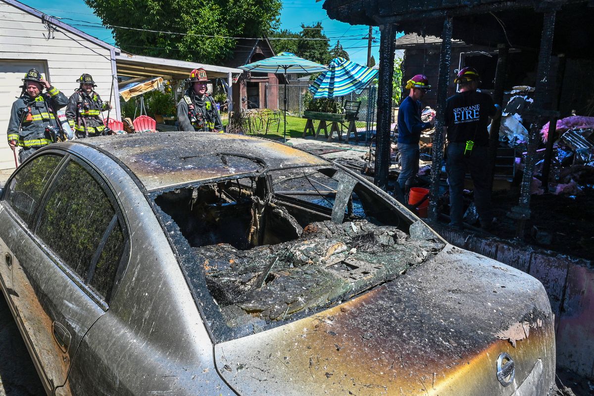 Spokane Fire Department crews were on the scene of a blaze Tuesday that destroyed the rear of a house, along with a Nissan Altima at 323 E. Nebraska Ave.  (Dan Pelle/The Spokesman-Review)