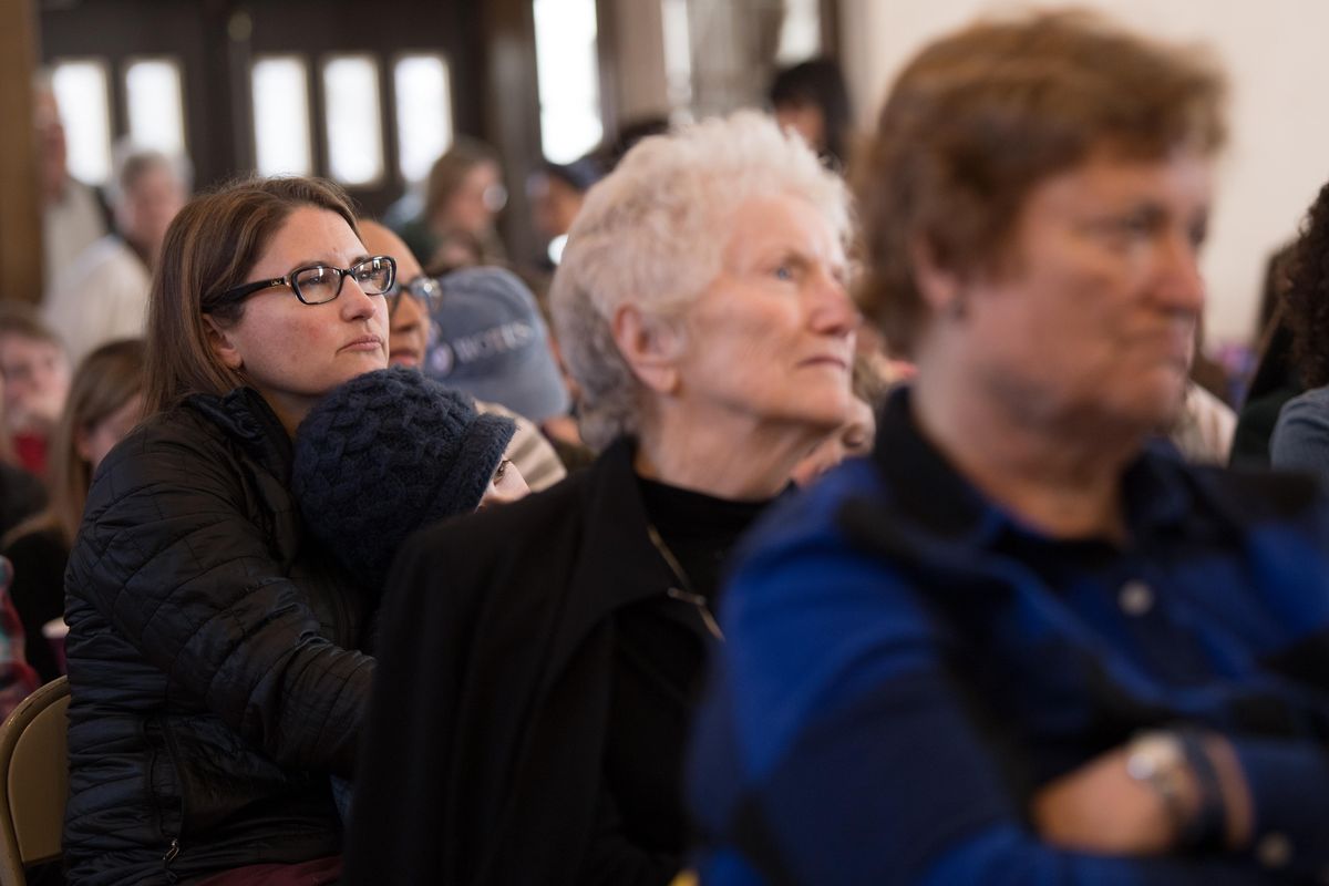 Kirsten Angell and her daughter Esther, left, listen with Elaine Tyrie, center, as Sandy Williams speaks during a celebration of International Women’s Day 2018 on Saturday, March 10, 2018, at the Spokane Woman
