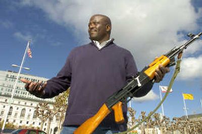 
Mikail Ali,  of the Mayor's Office of Criminal Justice, holds a rifle collected during San Francisco's 