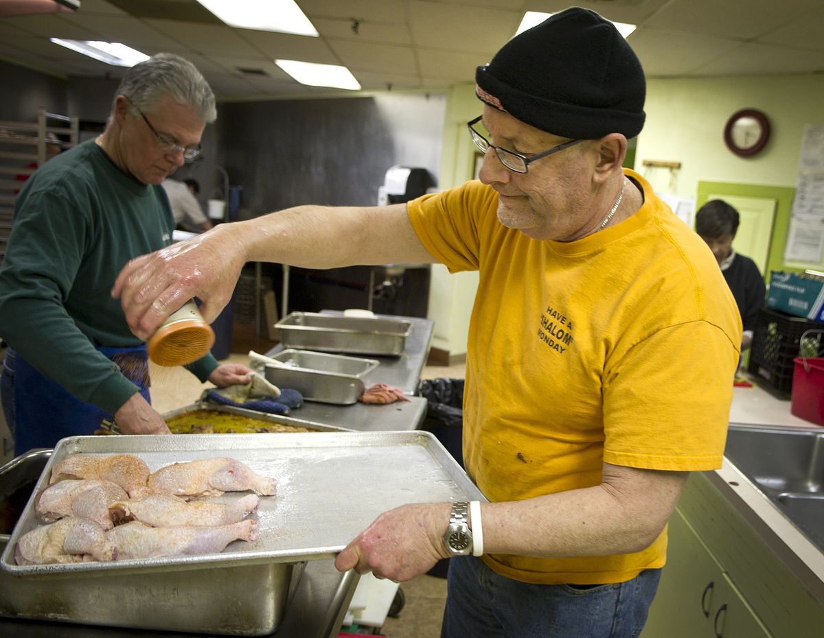 Volunteer John “Gus” Olsen prepares a meal in the basement kitchen of Central United Methodist Church on Third Avenue in downtown Spokane. Olsen is retiring after nearly five years as the chef for the homeless meal program run by Shalom Ministries. (Colin Mulvany)