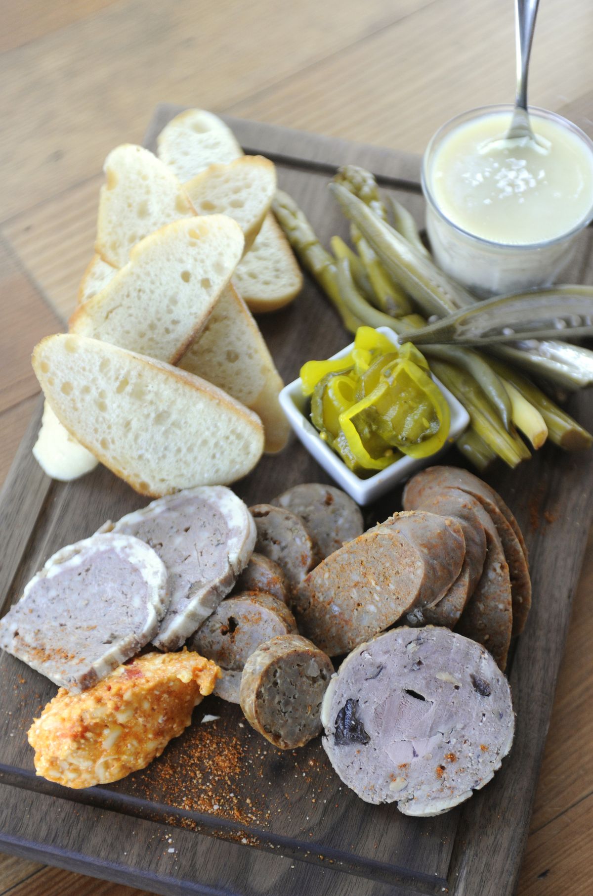 The Pantry Plate, a platter of sausages and pickled vegetables and condiments inspired by European cuisine, is among the offerings at Casper Fry. See more in Wednesday’s Food section. (Jesse Tinsley)