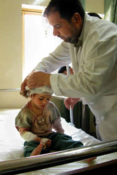 
A wounded Iraqi child is treated in a local hospital after insurgent attacks Thursday in Samarra, Iraq. 
 (Associaeted Press / The Spokesman-Review)