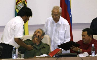 
Bolivian President Evo Morales, left, his Cuban counterpart Fidel Castro and Venezuelan President Hugo Chavez signed an endorsement of socialist trade Saturday in Havana. 
 (Associated Press / The Spokesman-Review)