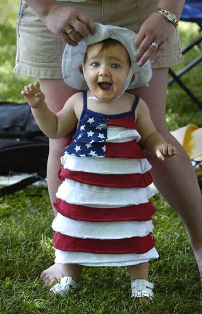 
Fayth Barker, 11 months, celebrates the Fourth with her parents, Doris and Jon Barker, on Neighbor Day in Riverfront Park.
 (Dan Pelle / The Spokesman-Review)
