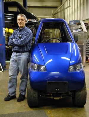 Rick Woodbury of Commuter Cars stands next to one of his ultra-thin electric cars in late 2007.   (File)