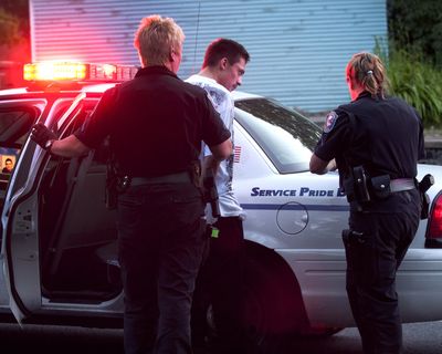 Spokane police take Josh Berg into custody near Seventh and Walnut on Tuesday night. Police thought Berg was a passenger in a car that was involved in a short police pursuit earlier. He wasn’t. (Colin Mulvany)