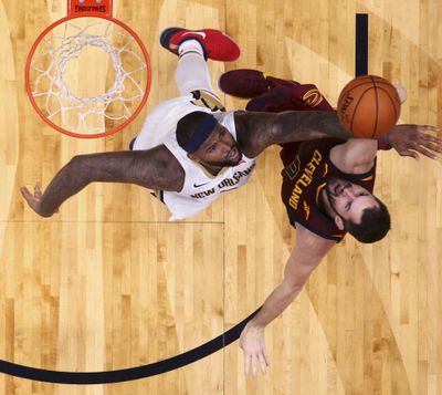 New Orleans Pelicans forward DeMarcus Cousins, left, challenges Cleveland Cavaliers forward Kevin Love as he goes to the basket during Saturday’s game. (Gerald Herbert / Associated Press)