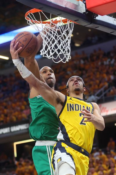 Indiana’s Andrew Nembhard drives for a layup against Boston’s Al Horford on Saturday at Gainbridge Fieldhouse in Indianapolis.  (Getty Images)