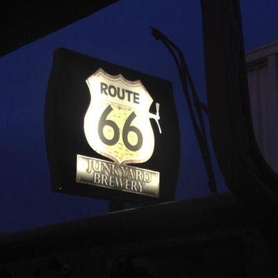 In this Dec. 10, 2015 photo provided by Henry Lackey, a sign for the Route 66 Junkyard Brewery is seen in Grants, N.M. The brewery is facing a U.S. federal lawsuit from the Cyprus-based Lodestar Anstalt over claims the hangout is illegally using the iconic American highway in its name. According to the lawsuit filed in U.S. District Court in Albuquerque, Lodestar owns the U.S. trademark for Route 66 beers in the country and the highway's “shield” that go on labels for beer. (Henry Lackey / Associated Press)