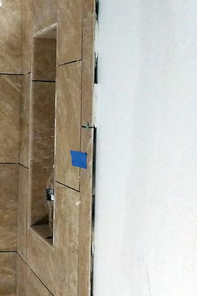 The horrible gap between the ceramic tile and the wall is not normal. The back of the tile should be flush with the wall. (Tim Carter)