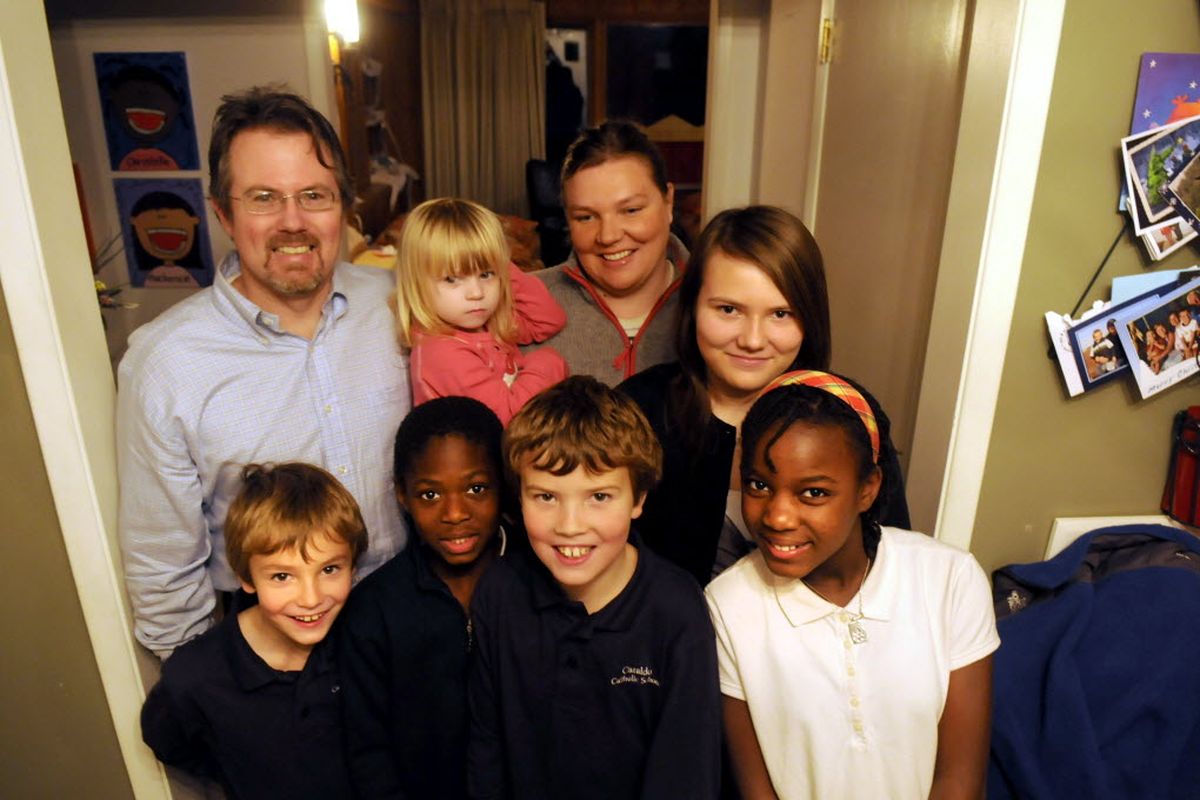 The Simpson family, that includes parents Brian and Angela in the back row, holding Lucy, 2, and, in the front row from left, Kobe, 7, Eckahelo, 8, Dane, 9, Christelle, 9, and Mackenzie, 13, is wondering about the whereabouts of their older brother Emarc in Haiti, but the family has had no word from him since the earthquake.  
  (Jesse Tinsley)