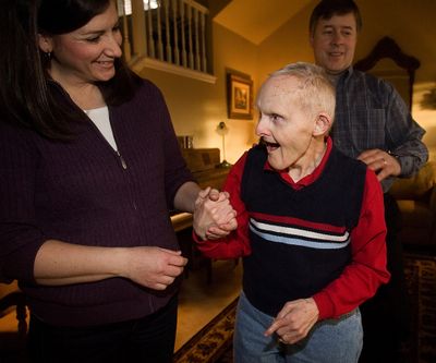 Veanne, left, and Van Elg, right, took Edgar in on the advice of Van Elg’s mother, then working at a group home where Edgar was living. “She thought he’d be good for us,” Veanne Elg said. “We weren’t sure at the time. He was a complete stranger. But we met him and fell in love with him.” They are pictured at the family home in West Boise, Idaho. McClatchy Tribune (McClatchy Tribune)