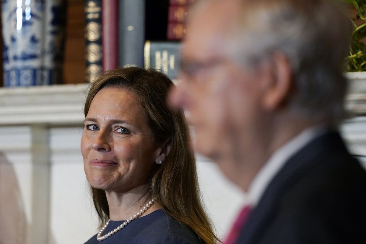 Supreme Court nominee Judge Amy Coney Barrett looks over to Senate Majority Leader Mitch McConnell of Kentucky as they meet with on Capitol Hill on Tuesday.  (Susan Walsh)