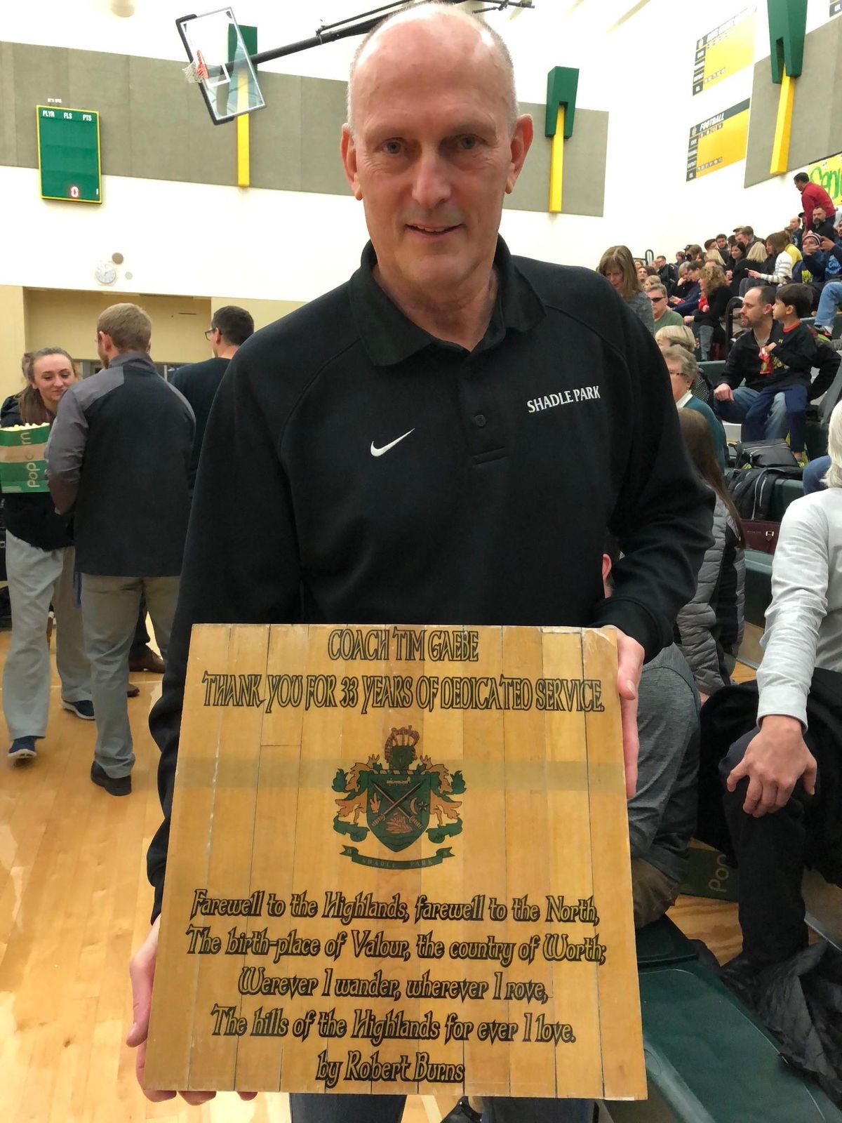 Former Shadle Park coach Tim Gaebe and the plaque presented to him by the school on Tuesday celebrating his 33 years of service. (Dave Nichols / The Spokesman-Review)