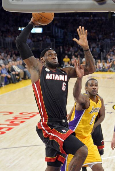 Miami Heat forward LeBron James dunks for two of his 39 points. (Associated Press)