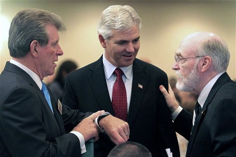 Gov. C.L. 'Butch' Otter, left, and Keith Allred, center, talk with moderator James Weatherby before their debate Wednesday Sept. 15, 2010 that was hosted by the City Club of Boise at the Grove Hotel in Boise, Idaho. (AP Photo/Times-News / Ashley Smith)