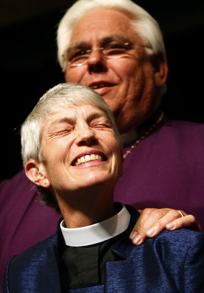 The Rev. Mary Glasspool reacts during her election Saturday in Los Angeles. Los Angeles diocesan Bishop Jon Bruno  stands behind her.  (Associated Press)