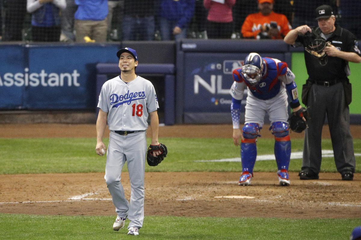 Los Angeles Dodgers relief pitcher Kenta Maeda walks back to the mound after throwing as wild pitch during the seventh inning of Game 6 of the National League Championship Series against the Milwaukee Brewers on Friday in Milwaukee. (Charlie Riedel / AP)