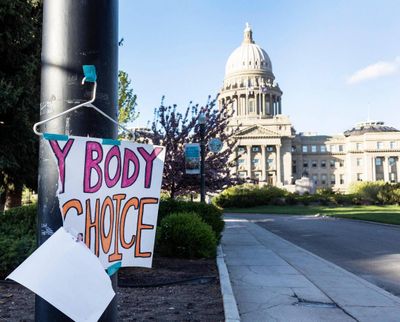 A sign is taped to a hanger taped to a streetlight in front of the Idaho Capitol on May 3.  (Sarah A. Miller/Idaho Statesman)