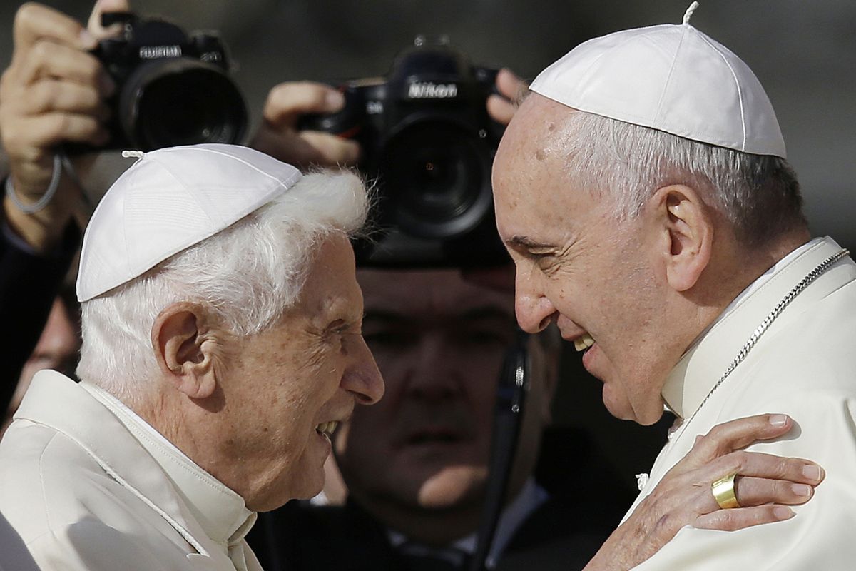 Pope Francis, right, hugs Emeritus Pope Benedict XVI prior to the start of a meeting with elderly faithful in September 2014 in St. Peter’s Square at the Vatican.  (Gregorio Borgia)