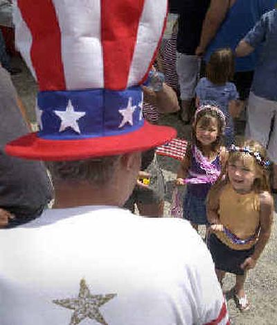 
Kinsie, 6, right, and Hailey Jones, 5, of Rathdrum check out Jack Soppit's Fourth of July garb while walking around Bayview, Idaho, Saturday morning after the annual Fourth of July parade. 
 (Jesse Tinsley / The Spokesman-Review)