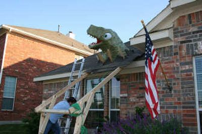 
Among the bizarre and quirky do-it-yourself projects offered by MAKE is a faux Tyrannosaurus rex crashing through a roof.  Photos courtesy MAKE Magazine
 (Photos courtesy MAKE Magazine / The Spokesman-Review)