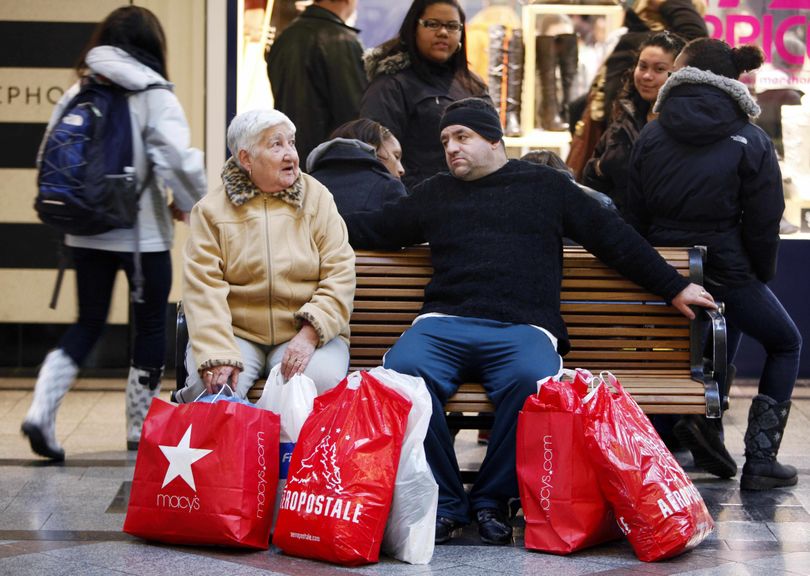 A pair of shoppers, who did not want to be identified, sit on a bench Monday at the CambridgeSide Galleria mall in Cambridge, Mass.Associated Press photos (Associated Press photos)