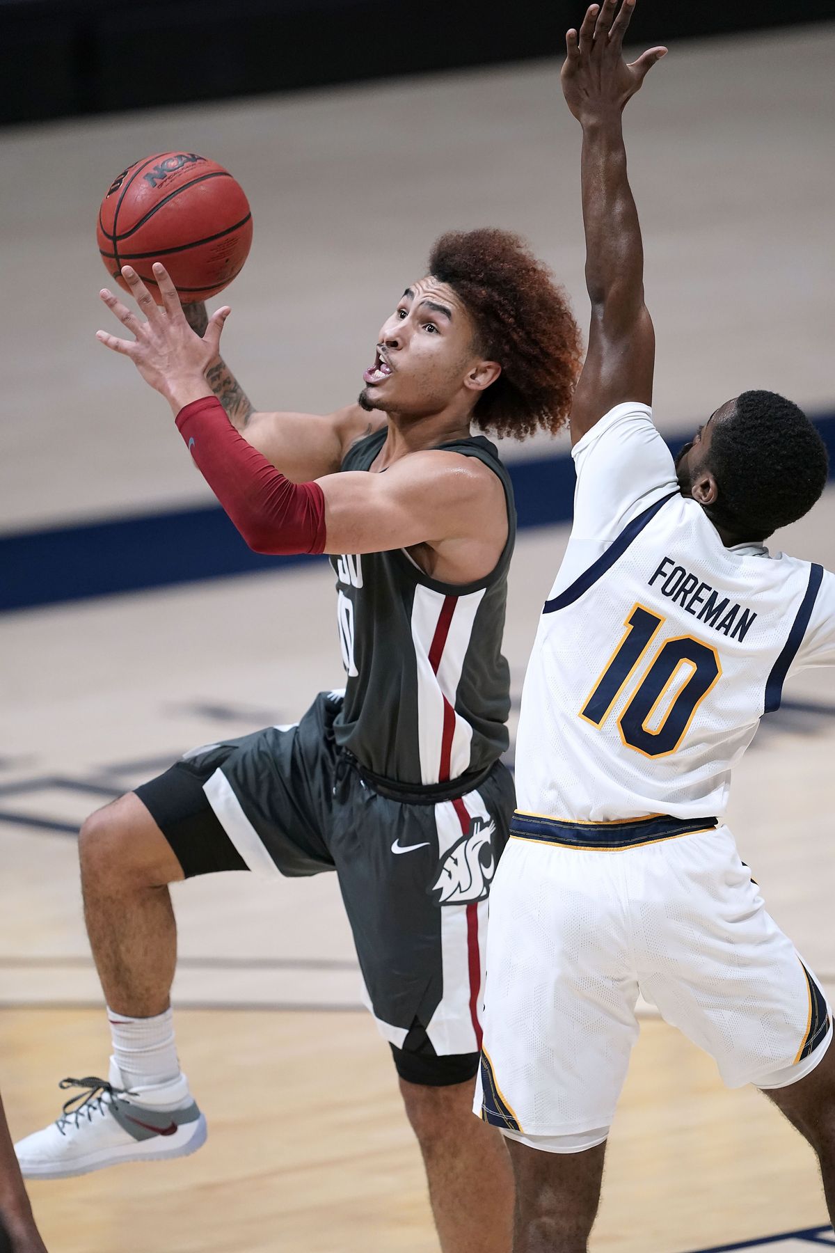 Washington State guard Isaac Bonton, left, drives to the basket against California guard Makale Foreman, right, during the first half of an NCAA college basketball game, Thursday, Jan. 7, 2021, in Berkeley, Calif.   (Associated Press)