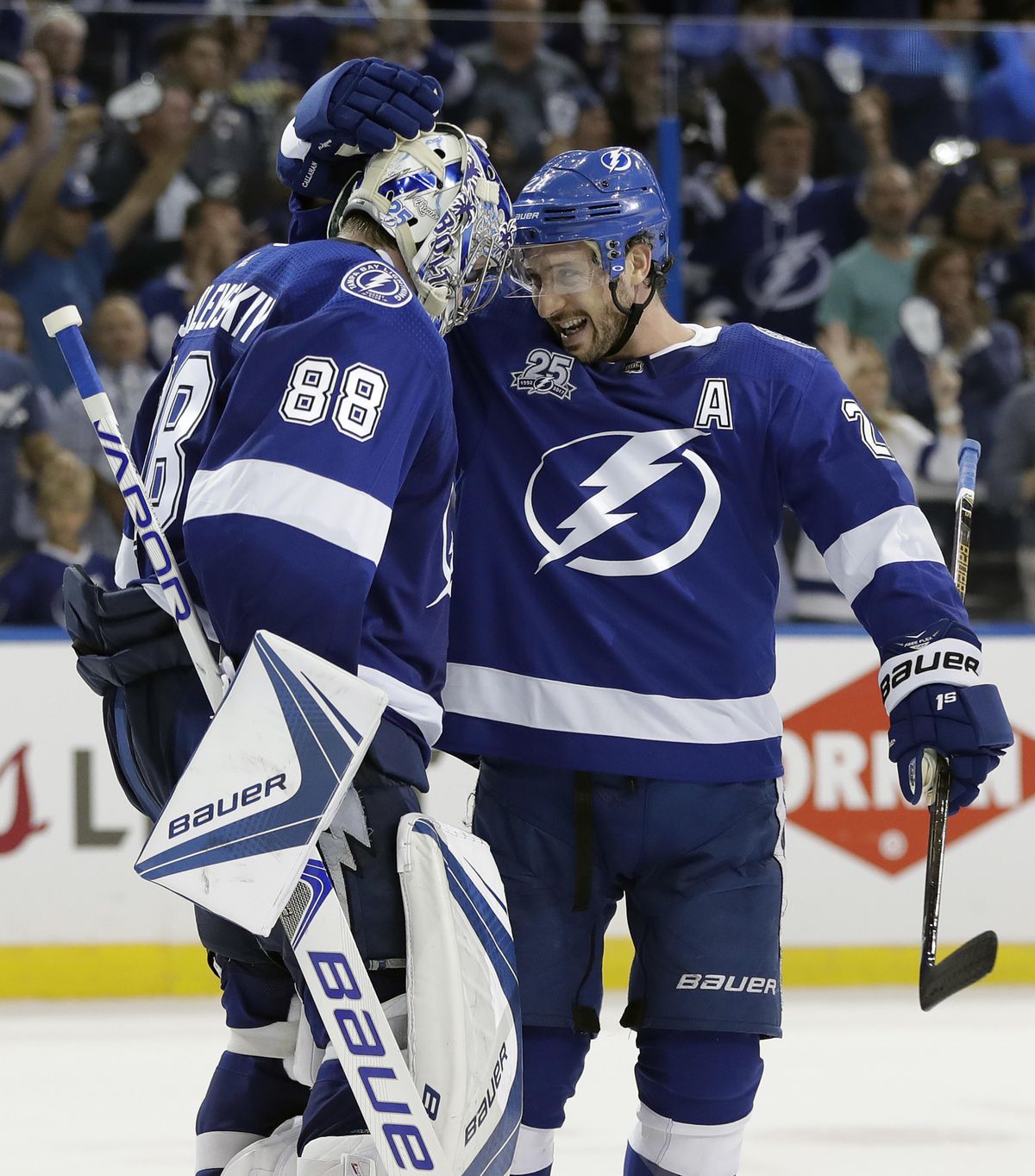 Tampa Bay Lightning goaltender Andrei Vasilevskiy (88) celebrates with Ryan Callahan (24) after the Lightning defeated the New Jersey Devils 5-2 during Game 1 of an NHL first-round hockey playoff series Thursday, April 12, 2018, in Tampa, Fla. (Chris O’Meara / Associated Press)