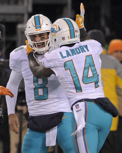 Miami Dolphins wide receiver Jarvis Landry (14) celebrates with quarterback Matt Moore (8) after scoring a touchdown against the New York Jets during the third quarter of an NFL football game, Saturday, Dec. 17, 2016, in East Rutherford, N.J. (Bill Kostroun / AP)