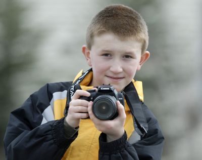 Jonas LaPier captures images with his digital camera. The 10-year-old has self-published two books of his photos, with the proceeds  benefitting Providence Sacred Heart Children’s Hospital.  (J. BART RAYNIAK / The Spokesman-Review)