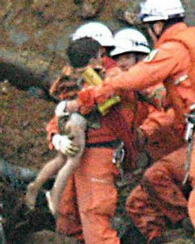 
Yuta Minagawa, 2, is carried by an  emergency worker during efforts to rescue a family of three, a mother and her two toddlers, from a van in Nagaoka in Niigata Prefecture on Wednesday. 
 (AP photo/Niigata Nippo via Kyodo News / The Spokesman-Review)