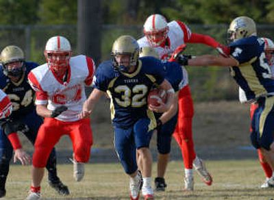 
Timberlake running back Nick Puckett breaks free of Weiser's defense during second-half action Saturday at Spirit Lake. 
 (Jesse Tinsley / The Spokesman-Review)