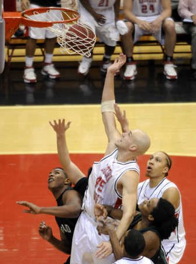 
Eastern's Brandon Moore, center, watches the game-winning shot of Kellen Williams, right. 
 (Dan Pelle / The Spokesman-Review)