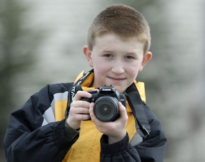Jonas LaPier captures images with his digital camera. The 10-year-old has self-published two books of his photos, with the proceeds benefitting Providence Sacred Heart Children’s Hospital. (J. BART RAYNIAK / The Spokesman-Review)