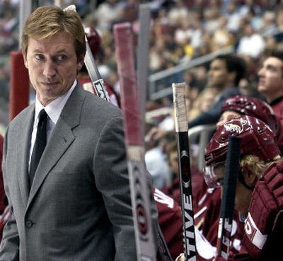 
Phoenix Coyotes coach Wayne Gretzky checks out his bench during first-period play on Saturday.
 (Associated Press / The Spokesman-Review)