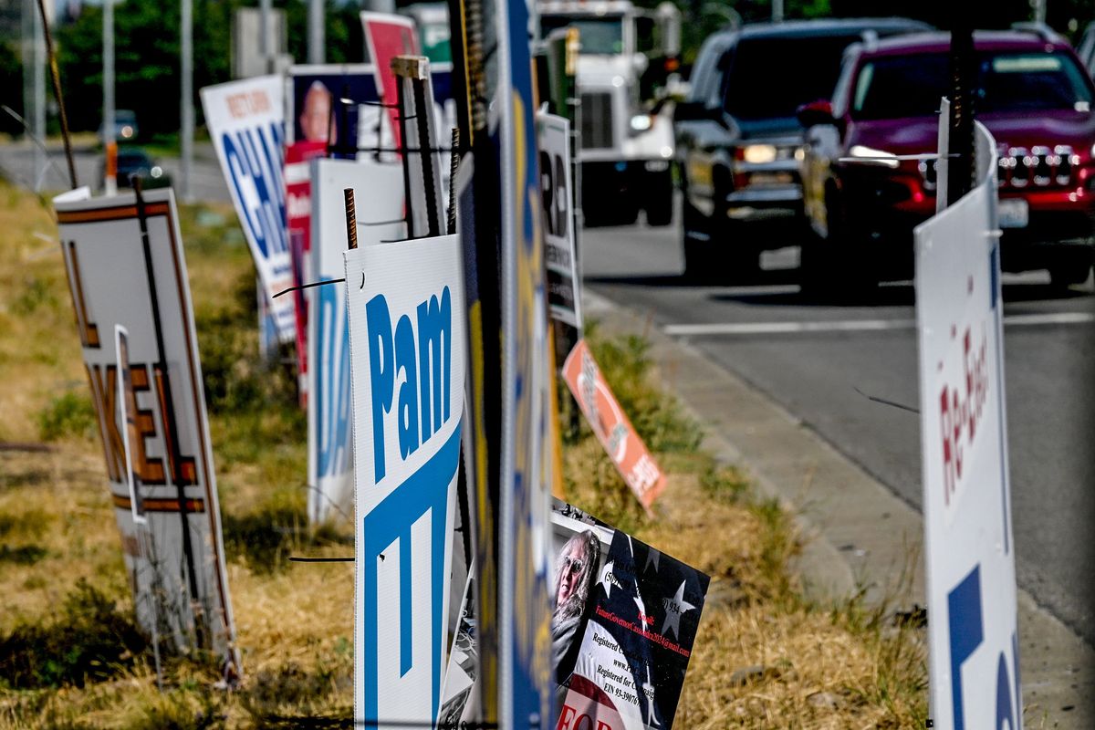 Political signs line the intersection of Indiana Avenue and Evergreen Road in Spokane Valley on Monday, the day before the primary election.  (Kathy Plonka/The Spokesman-Review)