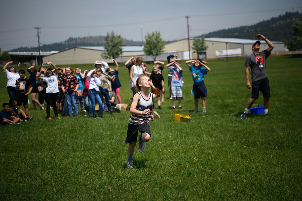 Jace Tsoumpas, 11, runs excitedly to retrieve his rocket after launching it on Tuesday, June 4, 2019, at Andrew Rypien athletic field in Spokane, Wash. The rocket launch was part of a STEM rocket program at Garfield Elementary School which is sponsored by The Rotary Club. (Tyler Tjomsland / The Spokesman-Review)