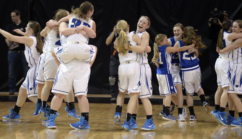 The Colton Wildcat girls celebrate after the 89-70 win over Sunnyside Christian, Saturday, Mar. 7, 2015, at the 1B Girls Hardwood Classic at the Spokane Arena. (Jesse Tinsley / The Spokesman-Review)