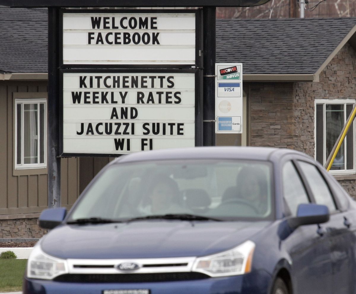 A motel marquee welcomes Facebook’s data center currently under construction in Prineville, Ore. The Greenpeace group says the largely coal-powered energy source for the center is more unfriendly to the environment than a less efficient facility would be.