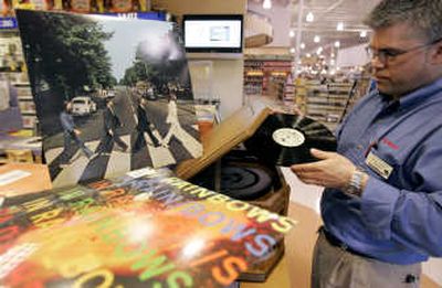 
Fred Meyer manager Dave Parker prepares to play the Beatles' 