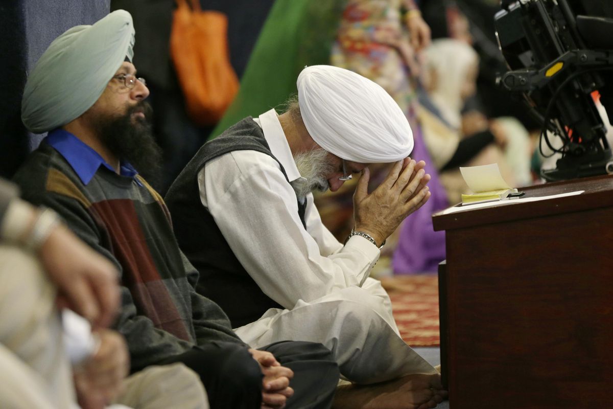 A man bows his head as he attends Sunday services at the Gurudwara Singh Sabha of Washington, a Sikh temple in Renton, Wash., Sunday, March 5, 2017, south of Seattle. (Ted S. Warren / Associated Press)